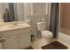 Bathroom featuring a toilet, bathtub with shower curtain, vanity, and tiled walls and floor at 421 Congress Pkwy, Lawrenceville, GA 30044