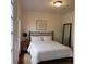 Cozy bedroom with natural light, queen bed, neutral decor, and hardwood floors at 421 Congress Pkwy, Lawrenceville, GA 30044