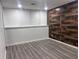 Bedroom featuring a wood accent wall, light-colored flooring, and bright lighting at 421 Congress Pkwy, Lawrenceville, GA 30044