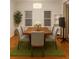 Bright dining room features a wood table, six chairs, and hardwood floors at 421 Congress Pkwy, Lawrenceville, GA 30044
