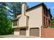 Side view of home featuring a two-car garage and brick wall at 421 Congress Pkwy, Lawrenceville, GA 30044