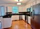 Kitchen featuring stainless steel appliances, black countertops, and white cabinets at 421 Congress Pkwy, Lawrenceville, GA 30044