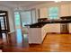 The hardwood flooring compliment the white counters and cabinetry, creating an open kitchen space at 421 Congress Pkwy, Lawrenceville, GA 30044