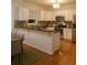 Modern kitchen featuring stainless steel appliances, black countertop, and a breakfast bar at 421 Congress Pkwy, Lawrenceville, GA 30044
