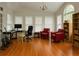 Bright room with hardwood floors, large windows, and comfortable red chairs creating a welcoming space at 421 Congress Pkwy, Lawrenceville, GA 30044