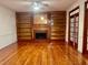 Spacious living room boasts custom built-ins, hardwood floors, a brick fireplace, and large windows at 421 Congress Pkwy, Lawrenceville, GA 30044