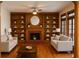 Elegant living room features custom built-ins, a cozy fireplace, and hardwood floors at 421 Congress Pkwy, Lawrenceville, GA 30044