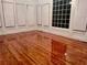 Bright living room featuring hardwood floors, neutral walls, and large windows with white trim at 421 Congress Pkwy, Lawrenceville, GA 30044