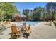 Community swimming pool with tables, chairs, and plenty of seating for residents at 421 Congress Pkwy, Lawrenceville, GA 30044