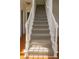 Carpeted staircase with white banisters and newel posts, transitioning from hardwood flooring at 421 Congress Pkwy, Lawrenceville, GA 30044