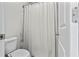 Cozy bathroom featuring a toilet, shower with a curtain, and bright lighting at 553 Onyx Lndg, Marietta, GA 30064