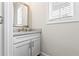 Stylish powder room with granite countertop, modern faucet, and decorative mirror at 553 Onyx Lndg, Marietta, GA 30064