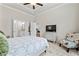 Cozy bedroom boasts a tray ceiling, TV on dresser, and view into ensuite bathroom at 553 Onyx Lndg, Marietta, GA 30064