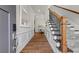 Inviting foyer with hardwood floors, wainscoting, staircase, and access to the dining room at 553 Onyx Lndg, Marietta, GA 30064