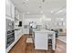Open-concept kitchen with stainless steel appliances and island extending into a cozy living area at 553 Onyx Lndg, Marietta, GA 30064