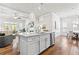 Bright kitchen island seamlessly connects the living room and dining area with hardwood floors at 553 Onyx Lndg, Marietta, GA 30064
