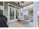 Comfortable outdoor patio with furniture, ceiling fan and double doors leading inside at 553 Onyx Lndg, Marietta, GA 30064