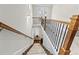 Elegant staircase leading to the lower level with carpeted steps and wood railing at 553 Onyx Lndg, Marietta, GA 30064