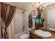Well-maintained bathroom with a shower-tub combo, decorative curtains, and modern fixtures at 6245 Hickory Lane Cir, Union City, GA 30291