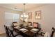 Elegant dining room featuring a dark wood table, decorative artwork, and stylish chandelier at 6245 Hickory Lane Cir, Union City, GA 30291