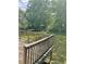 A wooden deck overlooks a lush green backyard with mature trees at 6399 Boca Grande Blvd, Forest Park, GA 30297