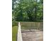 A backyard with a wooden deck and lush green trees at 6399 Boca Grande Blvd, Forest Park, GA 30297