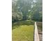 A well-maintained backyard is visible from the wooden deck, surrounded by trees at 6399 Boca Grande Blvd, Forest Park, GA 30297