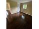 This is a bedroom with hardwood floors, a window, and a closet for ample storage at 6399 Boca Grande Blvd, Forest Park, GA 30297