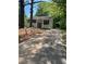 View of home's driveway framed by mature trees and lush foliage leading up to a quaint residence at 6399 Boca Grande Blvd, Forest Park, GA 30297