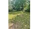 A vacant front yard with a luscious green lawn with some sparse patches ready for a new home to be constructed at 6399 Boca Grande Blvd, Forest Park, GA 30297
