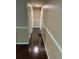 Long hallway with hardwood style floors at 6399 Boca Grande Blvd, Forest Park, GA 30297