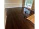 Bright living room featuring hardwood floors, large window, and neutral paint, with stairs nearby at 6399 Boca Grande Blvd, Forest Park, GA 30297