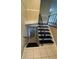 View of the staircase leading to a finished basement with tiled floors at 6399 Boca Grande Blvd, Forest Park, GA 30297