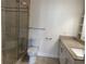 A clean bathroom with granite countertop, white cabinets, and a glass shower at 1101 Juniper Ne St # 1506, Atlanta, GA 30309