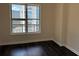 Cozy bedroom with hardwood floors, a large window with a great view, and neutral paint at 1101 Juniper Ne St # 1506, Atlanta, GA 30309