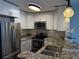 Bright kitchen features granite countertops, stainless steel appliances, and modern pendant lighting at 1101 Juniper Ne St # 1506, Atlanta, GA 30309