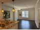 Bright living room featuring hardwood floors, modern lighting and an open concept connecting to the kitchen bar at 1101 Juniper Ne St # 1506, Atlanta, GA 30309