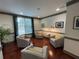 Inviting lounge area with hardwood floors, neutral armchairs, and decorative pillows at 1101 Juniper Ne St # 1506, Atlanta, GA 30309