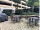 Outdoor patio with brick pavers, wrought iron furniture, and lush landscaping, ideal for relaxing or entertaining at 1101 Juniper Ne St # 1506, Atlanta, GA 30309