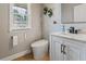 Chic half-bathroom features a toilet, sink, vanity, and natural light at 4230 Glen Vista Ct, Duluth, GA 30097
