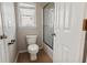 Clean bathroom featuring a toilet, window with blinds, and shower with sliding glass door at 4230 Glen Vista Ct, Duluth, GA 30097