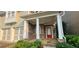 Inviting front entryway featuring a red door, stone accents, and a covered porch with classic white columns at 4230 Glen Vista Ct, Duluth, GA 30097
