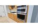 Stainless steel appliances in a modern kitchen, including a double oven and gas cooktop at 4230 Glen Vista Ct, Duluth, GA 30097