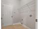 A dedicated laundry room featuring light wood floors and white walls, a shelf and washer-dryer hookups at 4230 Glen Vista Ct, Duluth, GA 30097