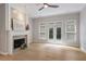 Bright living room features a fireplace, wood floors, and access to the yard through glass doors at 4230 Glen Vista Ct, Duluth, GA 30097