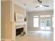 Spacious living room featuring a fireplace, ceiling fan, and French doors to the backyard at 4230 Glen Vista Ct, Duluth, GA 30097
