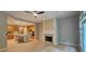Open-concept living space featuring a fireplace, wood floors, and kitchen with a breakfast bar at 4230 Glen Vista Ct, Duluth, GA 30097