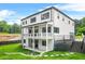 A stunning two-story home shows a spacious backyard with manicured lawn and a charming covered patio at 5175 Cascade Rd, Atlanta, GA 30331