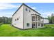 A side angle of the backyard shows the two-story home and its manicured lawn and covered patio at 5175 Cascade Rd, Atlanta, GA 30331
