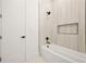 Beautiful bathroom with a white tub and a tiled wall with a sleek shower fixture at 5175 Cascade Rd, Atlanta, GA 30331